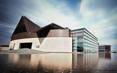 a large building sitting next to a body of water