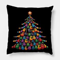 a christmas tree made out of guitars on a black pillow