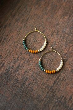 Unique boho earrings with glass seed beads (forest green,ivory,mustard colors), small gold tone metal beads and gold tone stainless steel round hoop earrings. Earring hooks are from nickel free and lead free metal. Perfect jewelry for everyday wear or a great gift for someone special! Diameter of hoops is 25 mm Other earrings of my shop you can see here: https://www.etsy.com/shop/NaTavelli?section_id=13757927  Thanks for visit. Small Boho Earrings, Earrings Trend 2024, Trending Earrings 2024, Diy Earrings Beads, Simple Beaded Earrings, Diy Beaded Earrings, Simple Bead Earrings, Earrings Seed Beads, Boho Jewelry Earrings