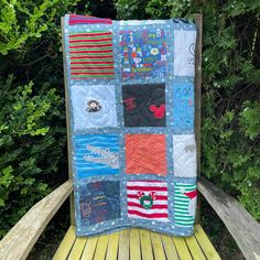 a patchwork quilt sitting on top of a wooden bench