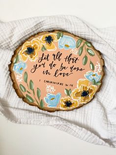 a painted wooden plaque with the words, but all that you do is love on it