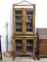 an old fashioned china cabinet next to other antique furniture