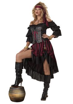 a woman dressed as a pirate posing for the camera with her leg up on a barrel