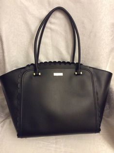 Kate Spade Maxime Maple Court black WKRU3680  Handbag tote Leather Satchel  with snap on closure     Gold tone hardware     Inside: Kate Spade logo lining with 2 slip pocket, 1 side zip pocket     Handles drop 8"     Approximate Dimensions - 18.5" (L) x 10.5" (H) x 6.5" (W) Large Elegant Black Bag, Elegant Large Black Shoulder Bag, Elegant Large Black Bag, Large Black Satchel With Top Carry Handle, Large Black Bag With Removable Pouch, Large Black Bag With Top Carry Handle, Large Black Chic Bags, Large Chic Black Satchel, Chic Large Black Bag