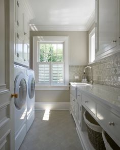 a laundry room with washer and dryer in it