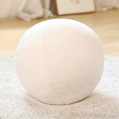 a large white ball sitting on top of a rug