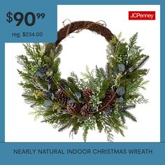 a christmas wreath with pine cones and evergreens on it is $ 90 99 reg $ 34 00