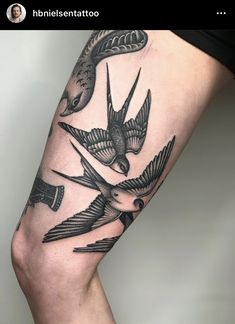 a woman's leg with two birds on it and an arrow in the middle