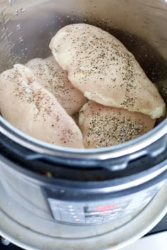 three pieces of chicken in an instant pot with seasoning on the top and bottom