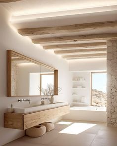 a bathroom with a sink, mirror and stone wall in it's center area