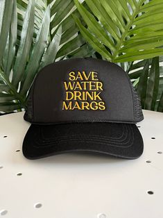 This is a one size fits most trucker hat. The back is mesh and breathable and it has an adjustable backing. It is a solid black with gold embroidery that says "save water drink margs". Fabric is 100% Polyester. Trucker Hat Black, Save Water Drink, Water Drink, Jewelry Candles, Gold Embroidery, Backpack Tote Bag, Scarf Hat, Dress Jewelry, Save Water