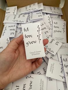 someone is holding up some cards with the words let love grow written on them in cursive writing