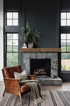 a living room filled with furniture and a fire place in front of two large windows