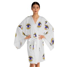 Add a touch of mystical elegance to your wardrobe with this stunning Evil Eye Purple & Gold Long Sleeve Kimono Robe! Made from luxurious, lightweight fabric, this kimono robe features a mesmerizing evil eye design in vibrant purple and gold hues. Perfect for lounging at home or making a statement at a special event, this robe adds a unique and stylish flair to any outfit. Embrace the intrigue and beauty of the evil eye symbol with this gorgeous kimono robe. Whether it's lounging at home or makin White Printed Kimono For Loungewear, White Sleepwear With Kimono Sleeves, White Kimono Sleeve Robe For Daywear, White Kimono With Kimono Sleeves For Daywear, White Wrap Kimono For Loungewear, Evil Eye Purple, Evil Eye Symbol, Mode Kimono, Long Sleeve Kimono