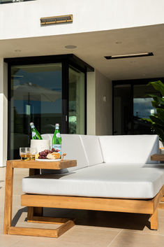 a white couch sitting on top of a wooden table