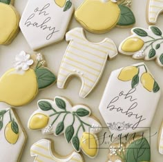 baby shower cookies decorated with lemons and white icing are displayed on a table