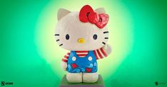 a hello kitty figurine with a red bow on it's head