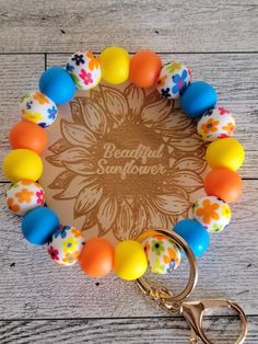 a colorful beaded bracelet with an orange, yellow and blue flower design on it