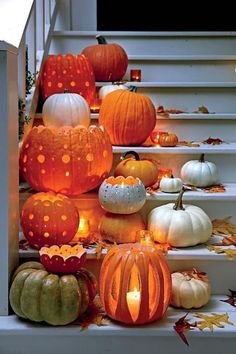 pumpkins and gourds are sitting on the steps