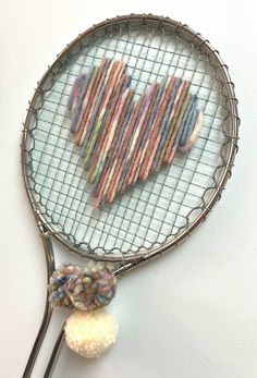 a tennis racket that has some yarn on it