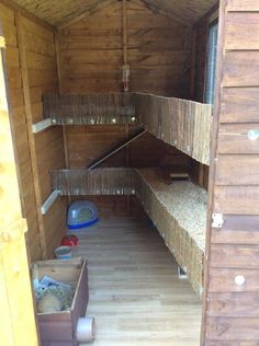 the inside of a small wooden cabin with bunk beds and other items on the floor