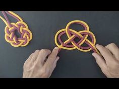 two hands are working on a piece of art that looks like an intertwined knot