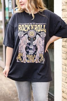 Our "Rock and Roll Tee" is a black t-shirt that that says "rock and roll" in yellow on the front. It has a guitar design on it. These are an oversized fit. Trendy Band Logo T-shirt For Concerts, Black Cotton Rock And Roll T-shirt, Rock Style Crew Neck T-shirt For Music Festival, Relaxed Fit Black Top For Music Festival, Black Relaxed Fit Top For Music Festival, Rock And Roll Graphic T-shirt For Music Festival, Rock Style Screen Print T-shirt For Music Festival, Rock Style Graphic T-shirt For Streetwear, Rock Style Graphic Print T-shirt For Streetwear