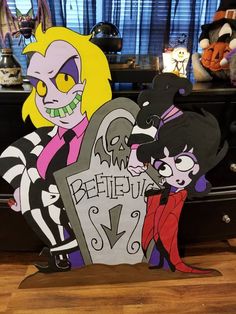 two cartoon characters are standing next to each other in front of a table with halloween decorations