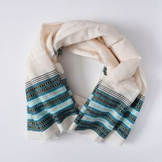 This scarf is hand spun and hand loomed by Ethiopian women maintaining traditional and minimalistic aesthetic, with contrasting  color combinations at the bottom. Generous size High quality  Handmade in Ethiopia  Measurements: L 64" x W 26.5" Care: Machine wash in cold water, hang dry and iron. Do not bleach. As with all handwoven textiles, there are slight variations making each piece a work of art and truly one-of-a-kind. Bohemian Cotton Shawl With Woven Motifs, Bohemian Cotton Handloom Scarves, Handwoven Cotton Bohemian Shawl, Handloom Cotton Folk Dupatta, Bohemian Cotton Dupatta With Weaving Work, Bohemian Cotton Handloom Shawl, White Bohemian Pashmina Scarf, White Cotton Shawl Scarves, White Cotton Shawl Scarf