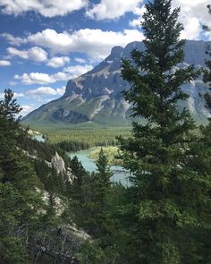 the mountains are surrounded by trees and water