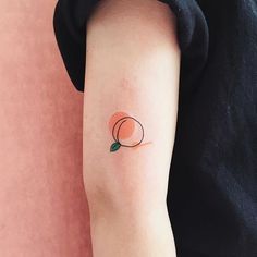 a small peach tattoo on the arm