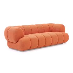 an orange couch sitting on top of a white floor