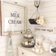 a kitchen with white walls and wood paneling has an old clock hanging on the wall