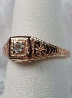 a gold ring with a diamond in the center