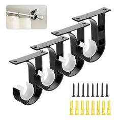 three black and white metal brackets with screws on each side, one is holding two hooks