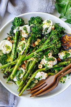 a white plate topped with broccoli and eggs