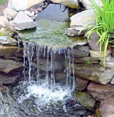 a small waterfall in the middle of some rocks