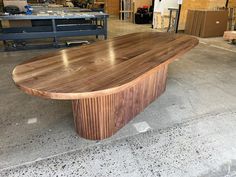 a large wooden table sitting in a warehouse