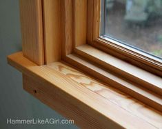 a wooden window sill sitting next to a window