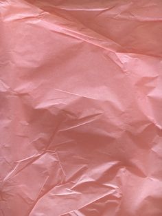 a piece of pink paper that is laying on the ground