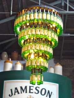 a chandelier made out of beer bottles hanging from the ceiling