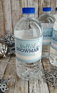 three water bottles with labels on them and the words melted snowman water bottle labels