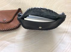 "This double coin purse is made with soft cowhide leather, a pocket on both sides with snaps, and even a pocket between the two . Hand laced and stitched to make it stronger, secured with a rivet on each side for strength, will make a nice gift. About 5-1/4\" wide x 3-1/2\" height closed. This coin purse will hold quite a few coins, bills, and one side will easily hold 13 or more credit cards. Terrific gift. Holds lots of money. Shipping insurance is included with postage. If you order multiple Leather Coin Purse With Cell Phone Pocket, Leather Coin Purse With Card Slots For Travel, Brown Coin Purse With Interior Card Slots, Leather Clutch Coin Purse With Cell Phone Pocket, Leather Shoulder Bag With Card Slots For Personal Use, Leather Coin Purse With Cell Phone Pocket As Gift, Leather Coin Purse With Interior Card Slots, Handmade Leather Coin Purse Clutch, Handmade Leather Coin Clutch