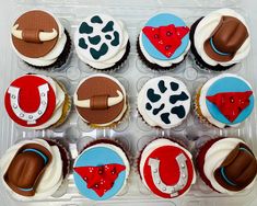 twelve cupcakes in a plastic container decorated with different designs and colors on them