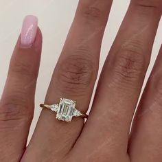 a woman's hand with a diamond ring on it