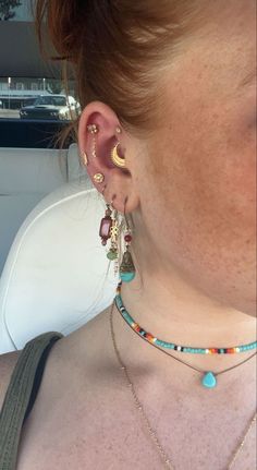 a close up of a person wearing some kind of earring with beads on it