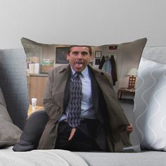 a man in a trench coat sitting on a couch with his tongue out throw pillow