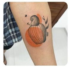 a tattoo on the leg of a person with an orange and black pumpkin in it