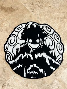 a black and white circular rug with an image of a monkey on it's face