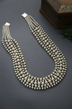 Black-White Gold Tone Beaded Necklace.Elegant and modern,White beaded necklace will complete your lavish ensemble grandeur. Necklace Size - 24 inches. Closure - Adjustable Style Tip - We love teaming this with classy chiffon sarees or zari silk sarees. Also looks best when worn with your royal whites, off whites and gold. We recommend styling with pastel solids or floral dresses in peachy pink, pistachio green and pastel blue too. Handcrafted in Jammu and Kashmir Paisley Pop travels the depths o Pearl Necklace Indian Jewelry, White Beaded Necklace, Chiffon Sarees, White Beaded Necklaces, Contemporary Necklace, Beaded Necklace Designs, Necklace Indian, Necklace Elegant, Necklace Pearl